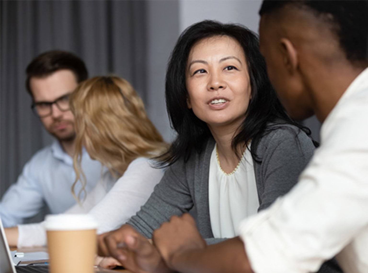 Asian middle-aged woman Asian middle-aged woman mentor teach African guy millennial intern